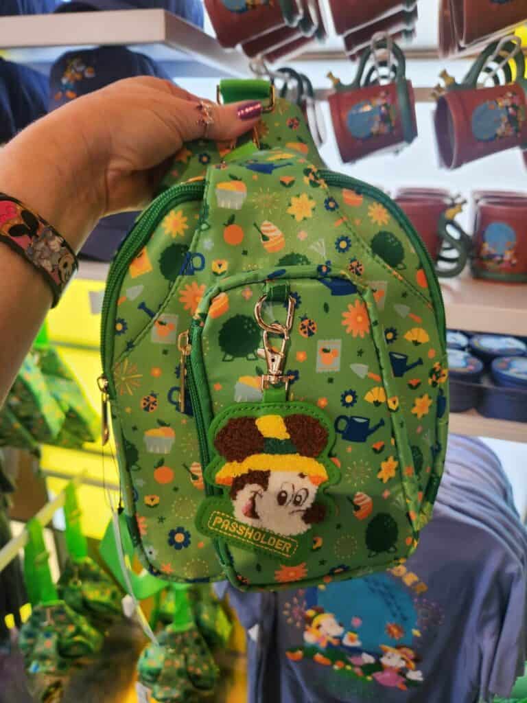 Backpack featuring Toy Story characters and vibrant green floral pattern.