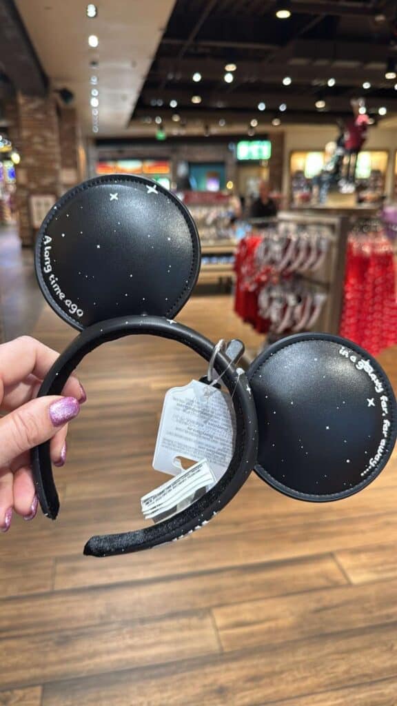 Minnie Mouse ears headband with starry night design for Disney fans.