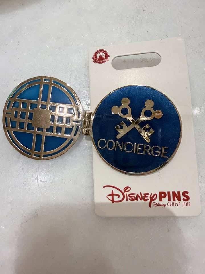 Disney Concierge badge with blue and gold design.