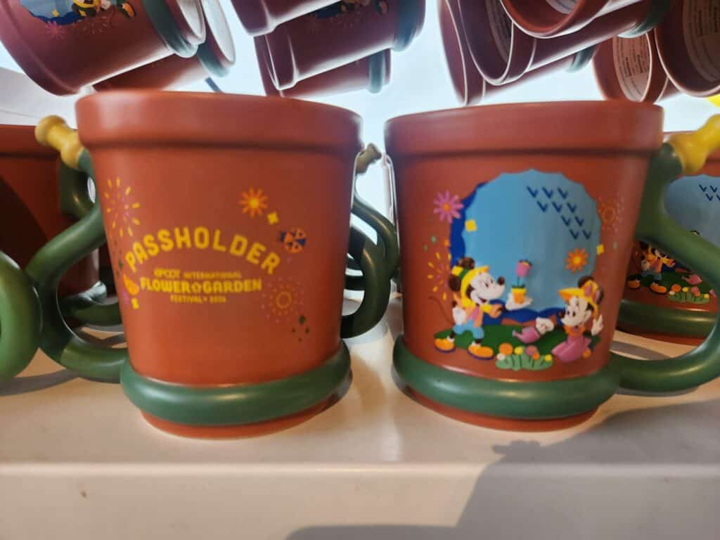 Disney Passholder mugs featuring Mickey and Minnie Mouse in a colorful garden scene.