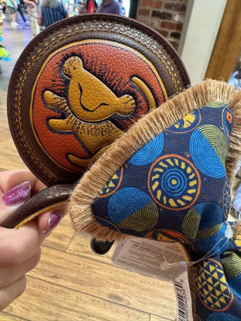 Disney coin purse with a matching patch featuring classic Disney characters and vibrant colors.