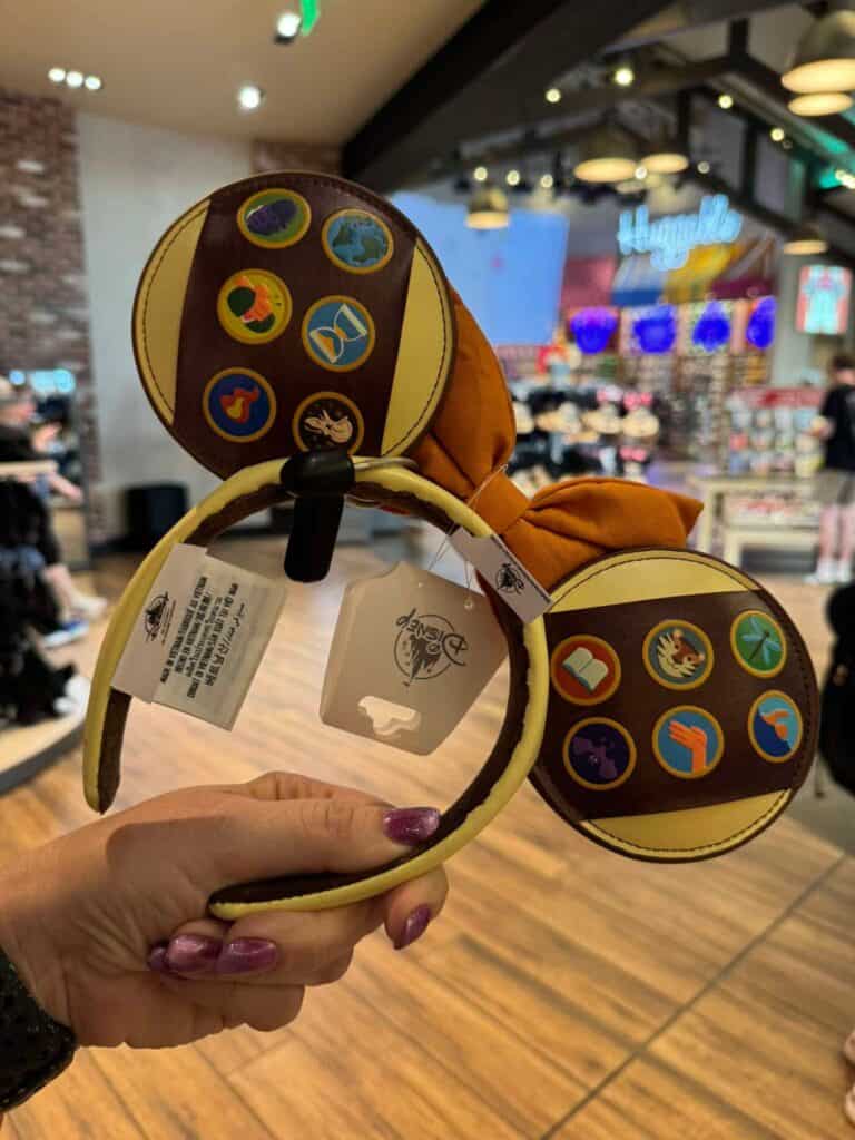 Minnie Mouse ears headband with colorful enamel pins for Disney fans.