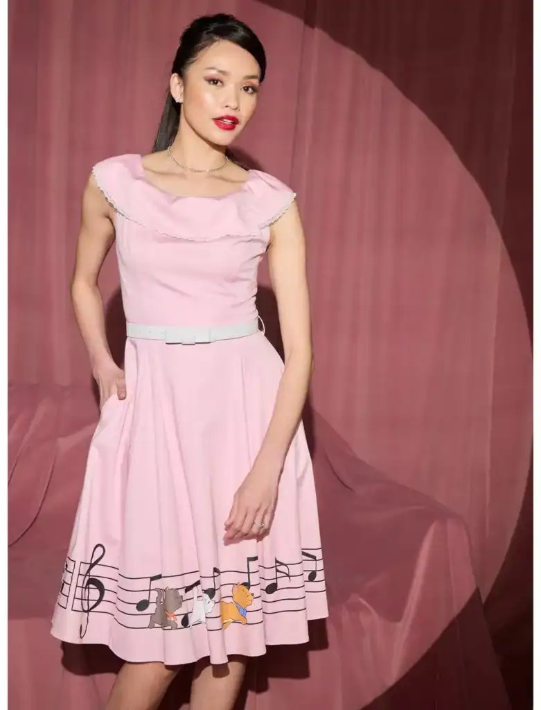 Elegant pink dress featuring Disney-themed musical notes and characters, perfect for Disney fans and.