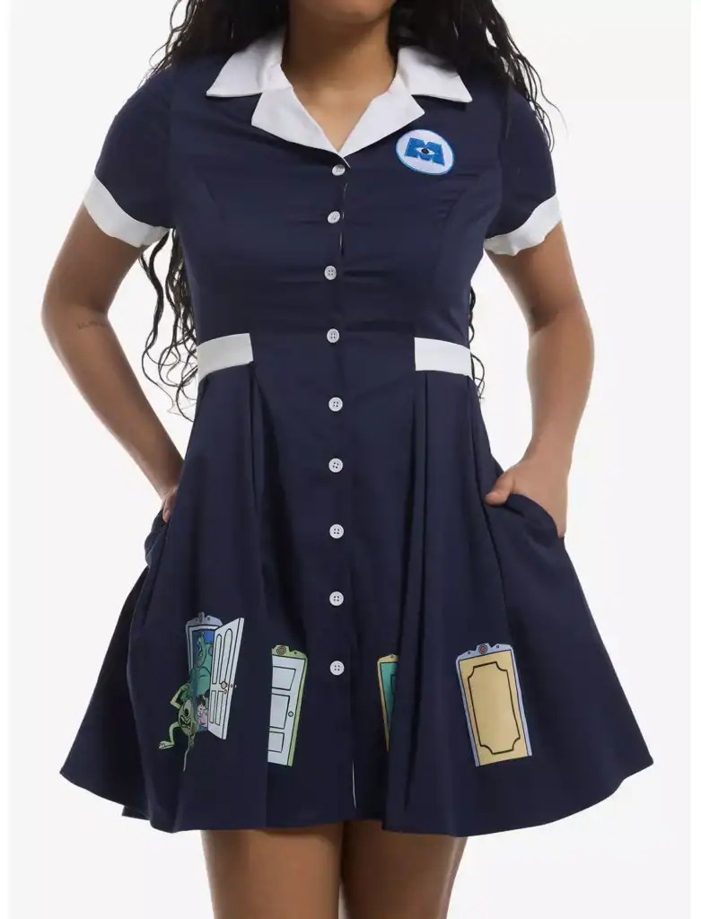 Navy blue school dress with Disney book print accents and white collar.