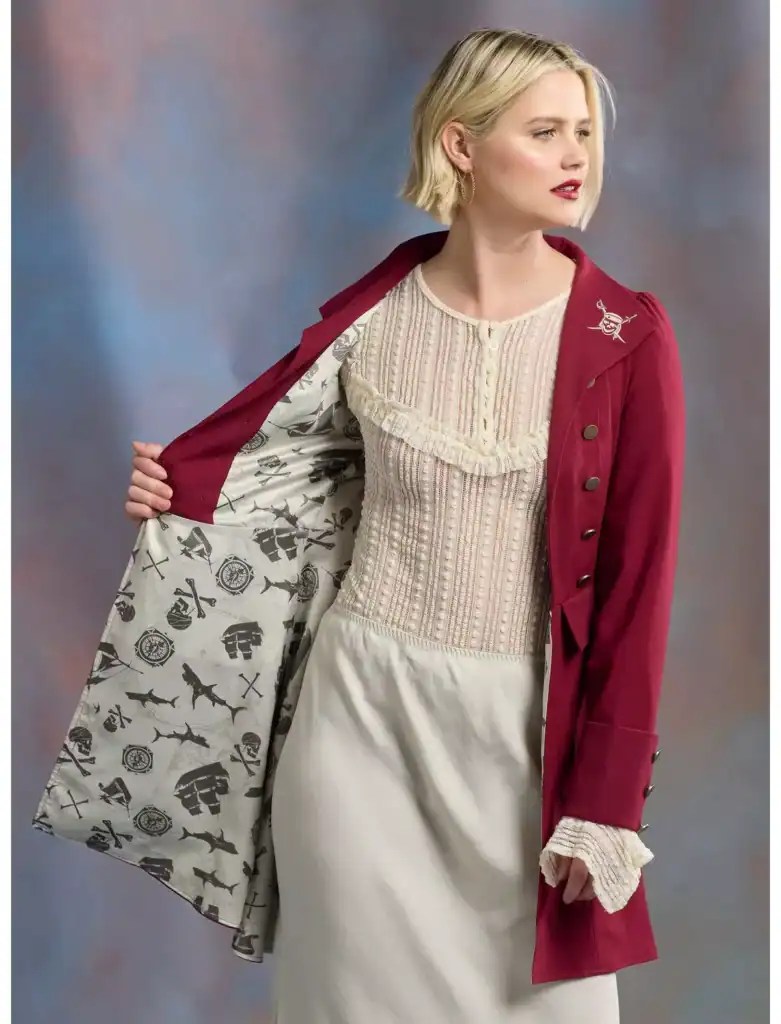 Elegant Disney-themed outfit with stylish coat and dress.