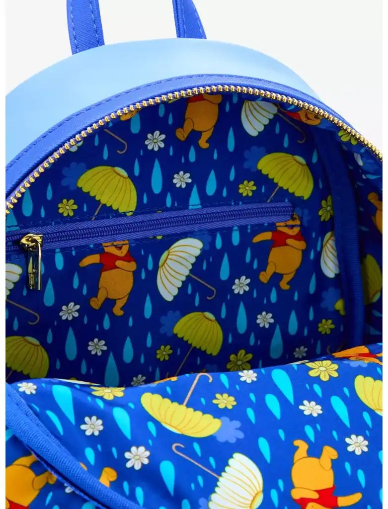 Winnie the Pooh themed backpack with rain and umbrella pattern, perfect for Disney fans.