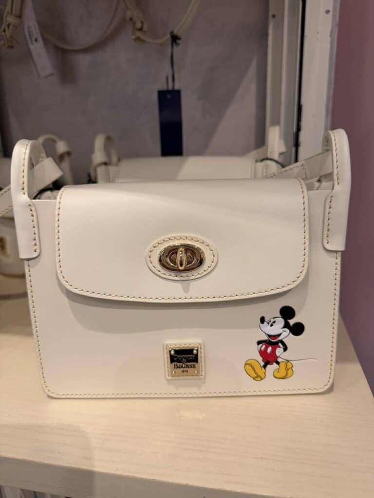 Neutral Mickey Mouse Dooney & Bourke crossbody bag with classic design.