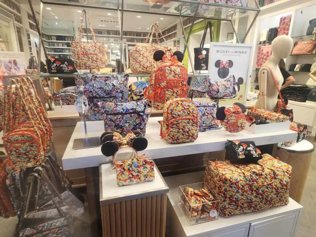 Mickey and Minnie floral bags from Disney x Vera Bradley collection on display.