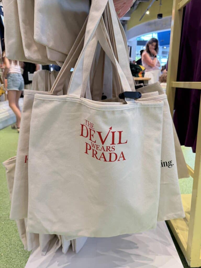 Canvas tote bag with "The Devil Wears Prada" logo, stylish and functional accessory.