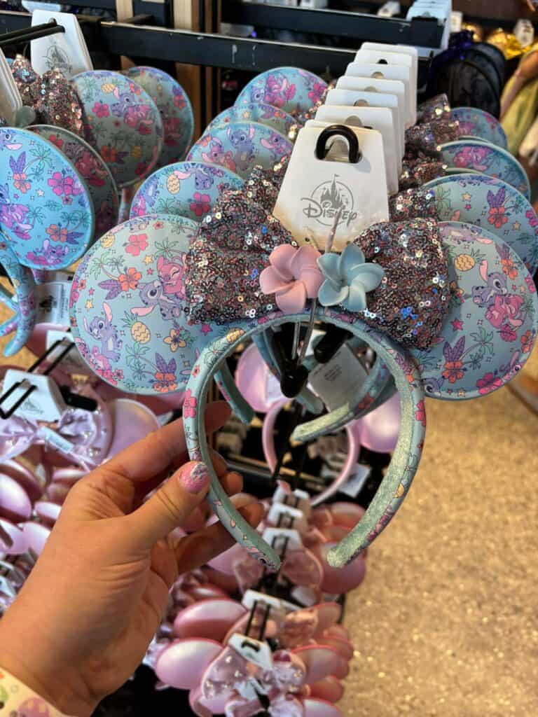 Disney Minnie Mouse ears headband with glitter bow and floral pattern, perfect for Disney fans.