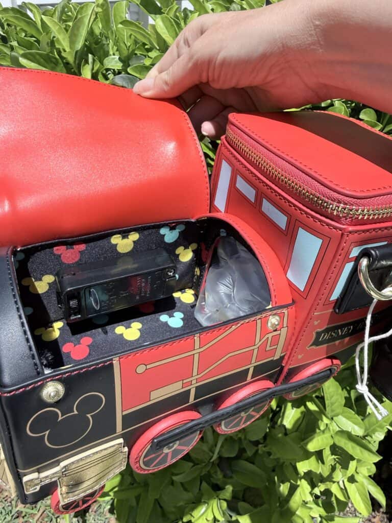 Red Disney train-themed bag with compartments and Mickey Mouse details.