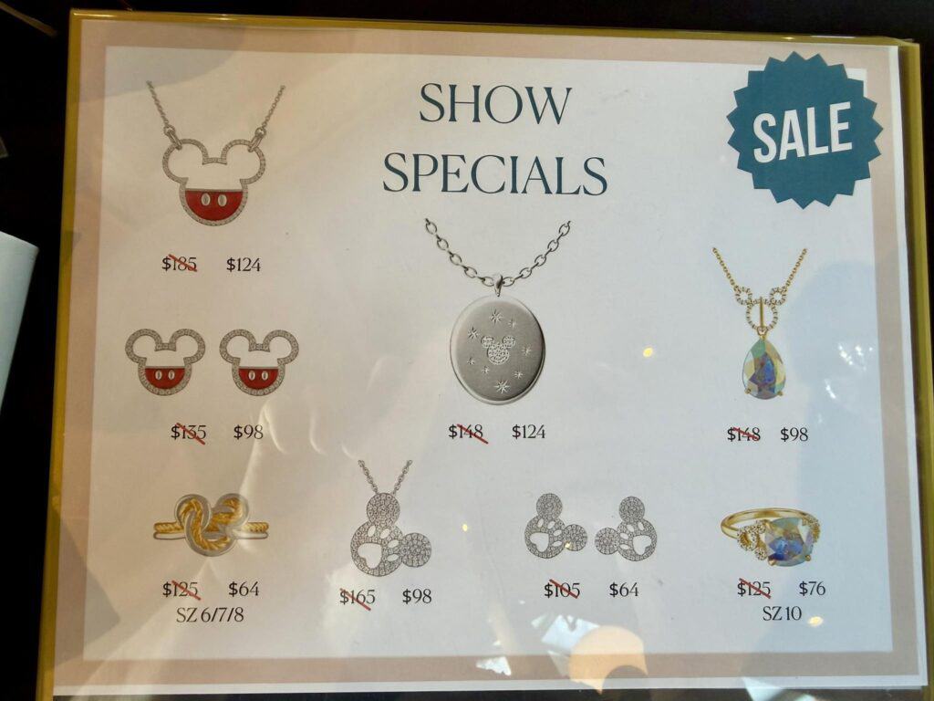 Disney jewelry sale featuring necklaces and earrings with sparkling designs.