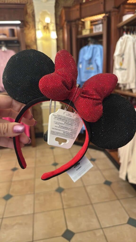 Minnie Mouse headband with red bow, black ears, perfect for Disney fans.