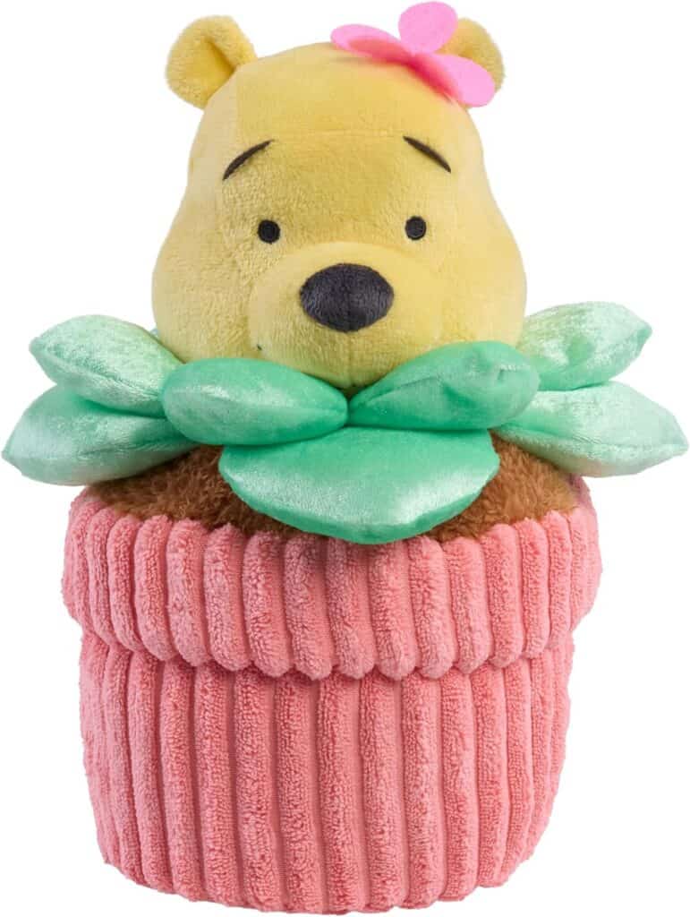 Adorable Winnie the Pooh plush plant in a pink knitted pot with green leaves. Perfect Disney collect.