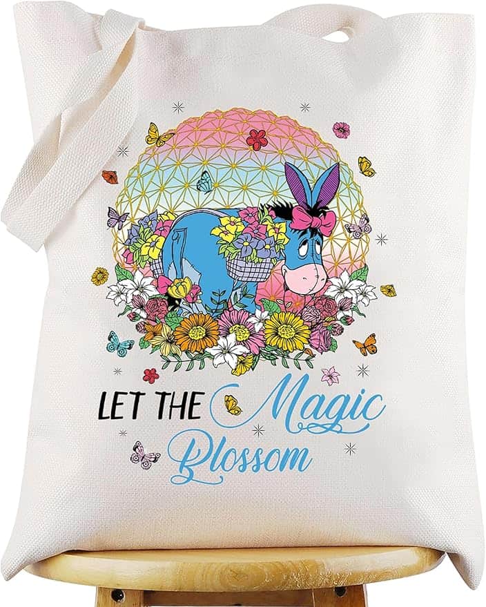 Eeyore tote bag featuring colorful flowers, butterflies, and a geometric background with the phrase.