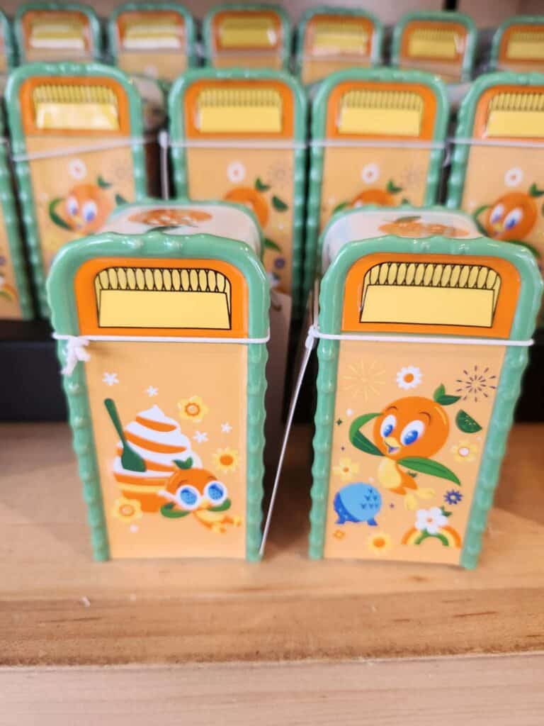 Bright orange and green pencil cases featuring Disney character illustrations.