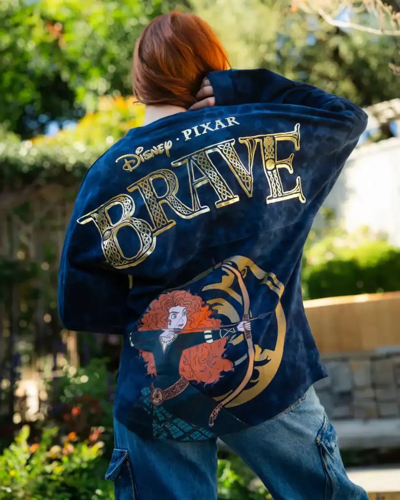Woman wearing a Disney Pixar Brave denim jacket outdoors.