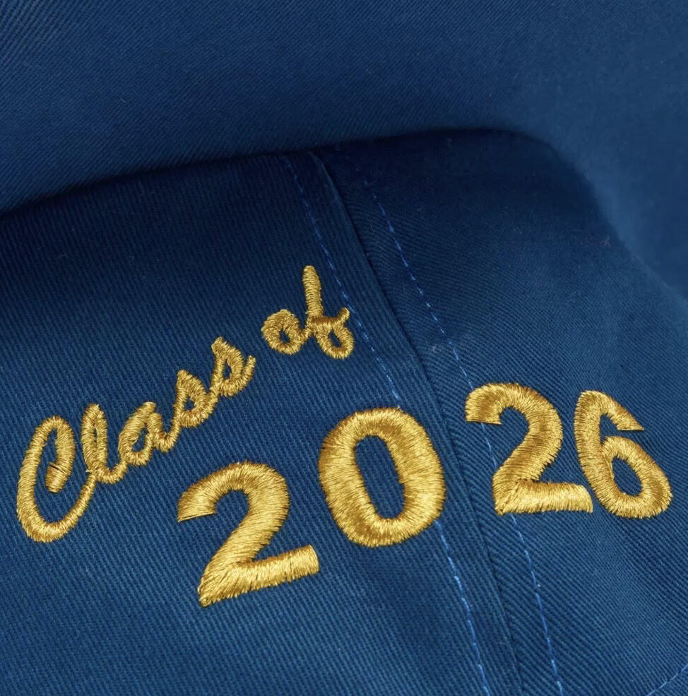 Blue graduation cap with gold embroidered "Class of 2026".