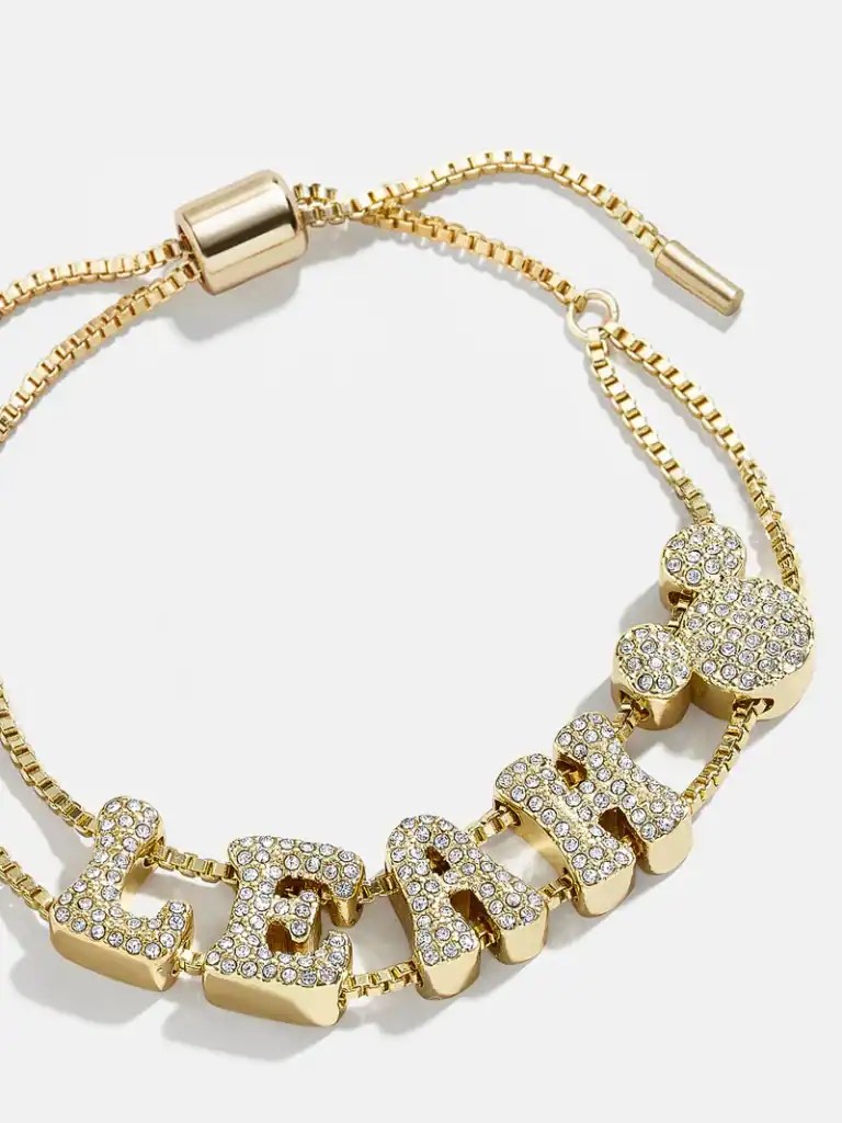 Elegant gold bracelet with sparkling letter charms spelling "LOVE" and a Mickey Mouse charm.