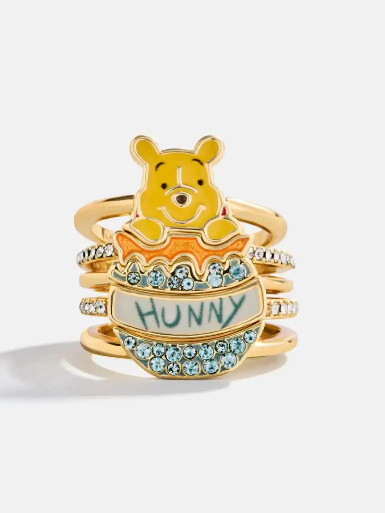 Gold Winnie the Pooh Hunny ring with blue crystals and "HUNNY" inscription.