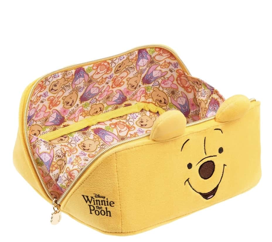 Winnie the Pooh themed cosmetic bag with adorable face design and floral interior.