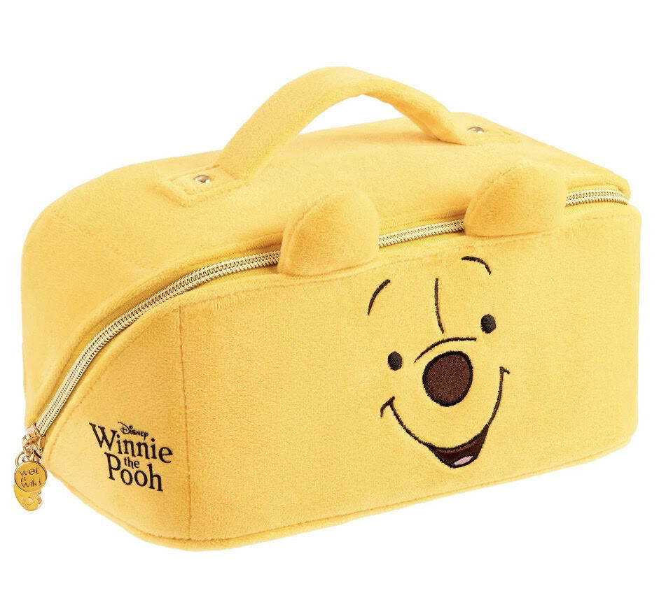 Yellow Winnie the Pooh plush travel bag with face and ears, perfect for kids.