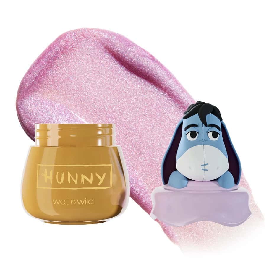 Cute Winnie the Pooh lip balm with Eeyore figurine for Disney fans.