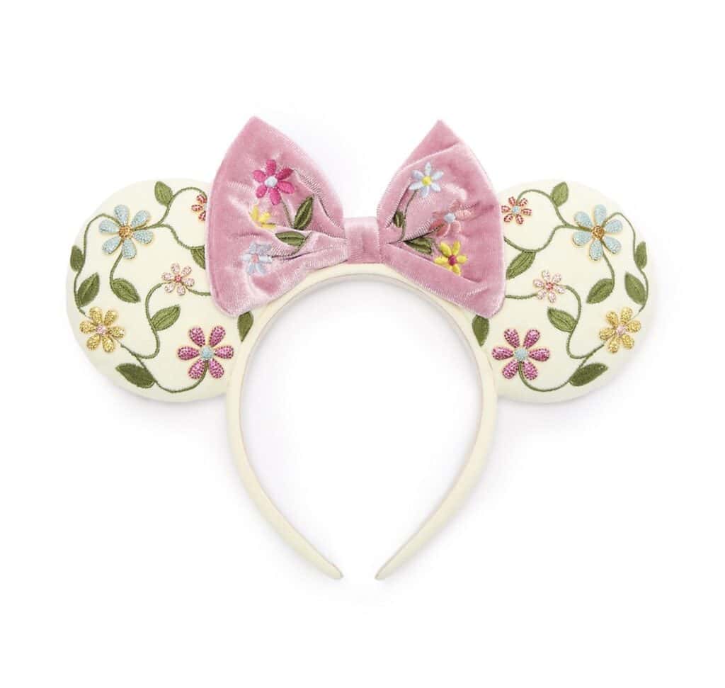Pink floral Minnie Mouse ears headband with embroidered bow, perfect for Disney fans.