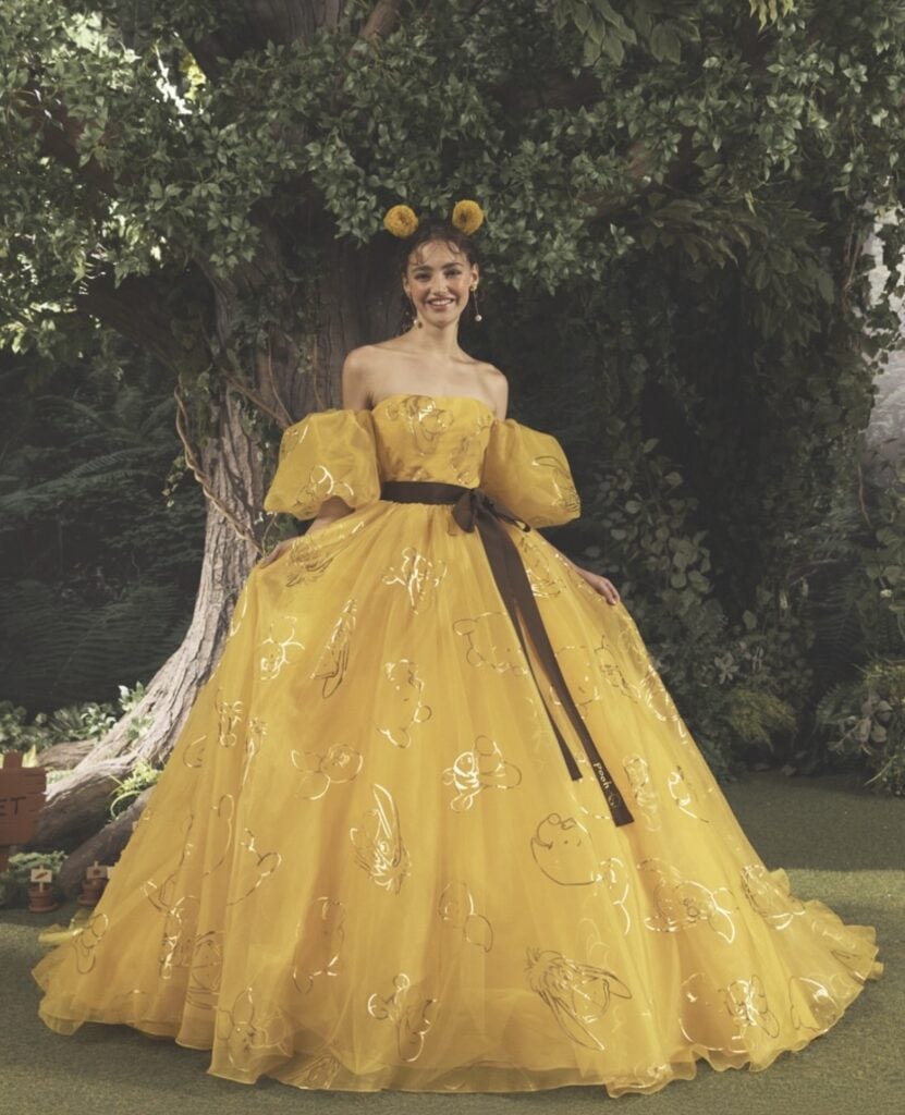 Elegant yellow Disney-inspired ball gown with floral embroidery and playful headband.