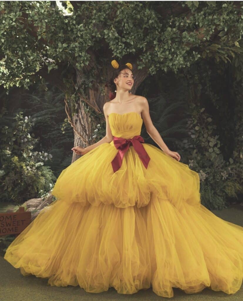 Elegant yellow ball gown with red bow, inspired by Disney princesses, perfect for cosplay or themed.