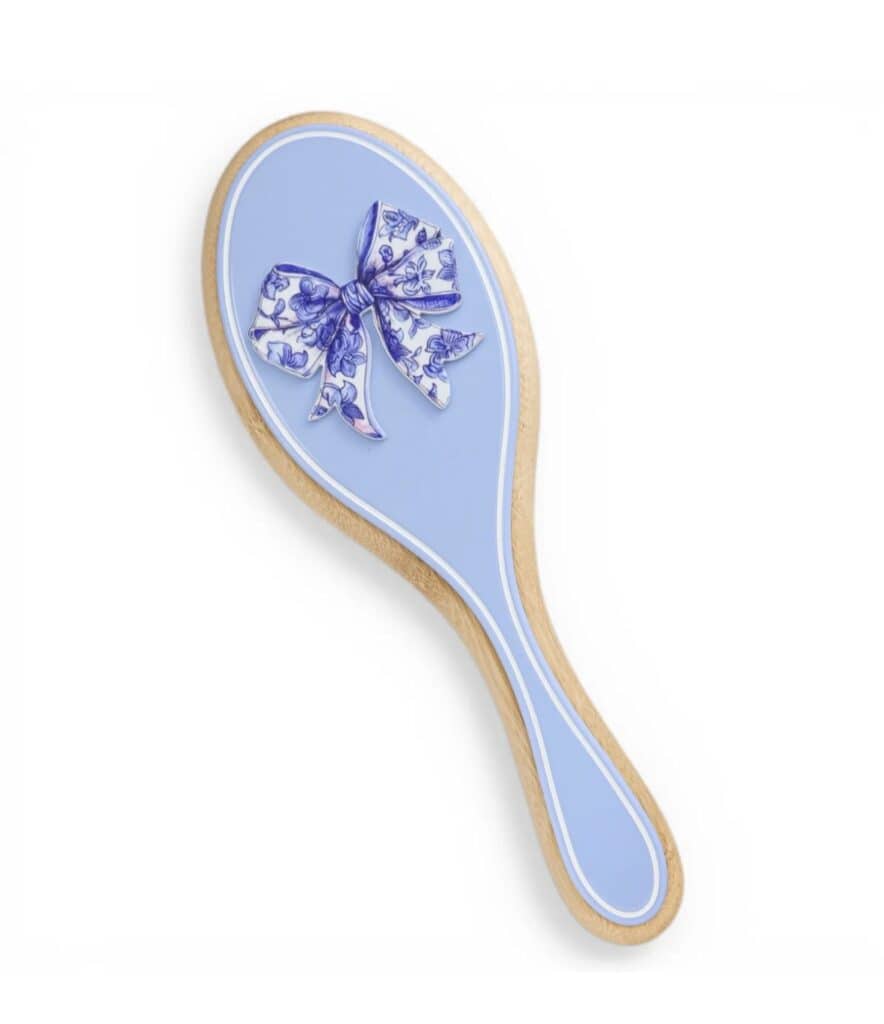 Blue hairbrush with floral bow design, perfect for Disney fans.