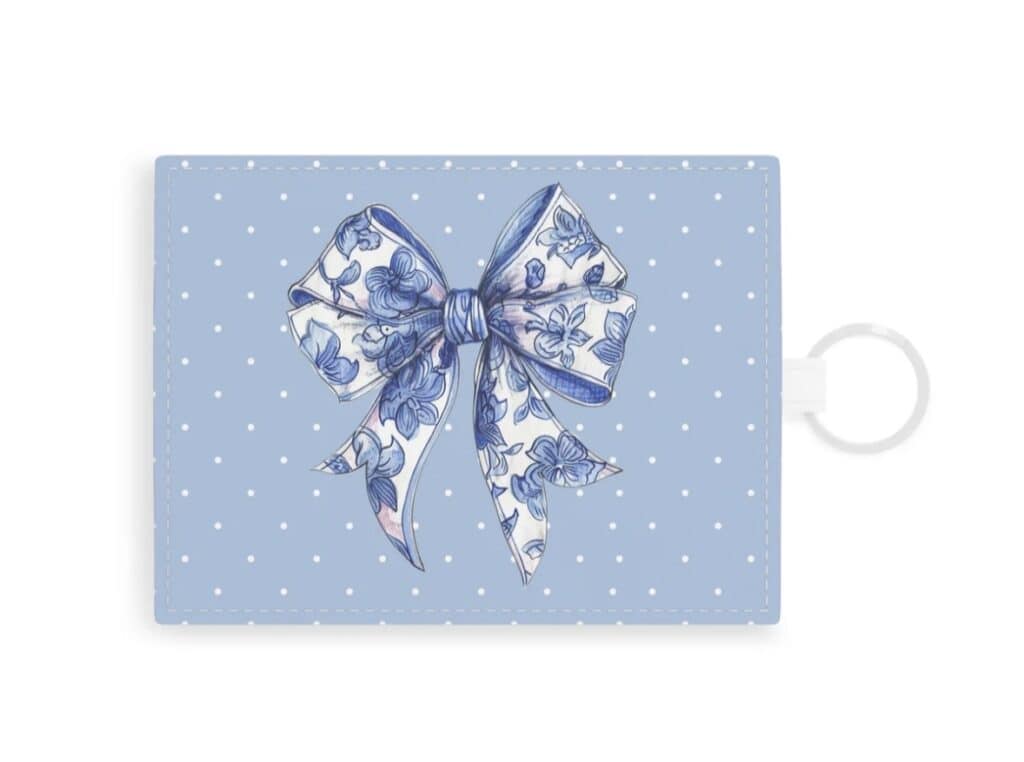 Blue floral bow keychain with elegant design and polka dot background.