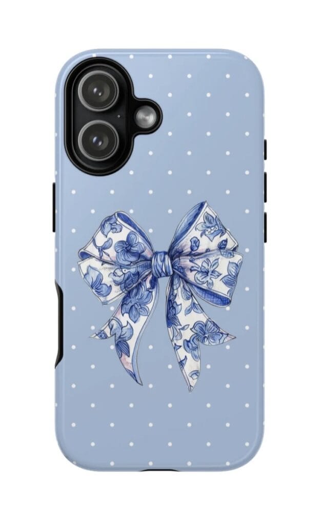 Blue phone case with floral bow design and polka dots for iPhone.