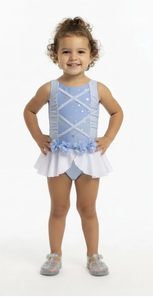 Young girl in blue and white ballet costume with floral details.