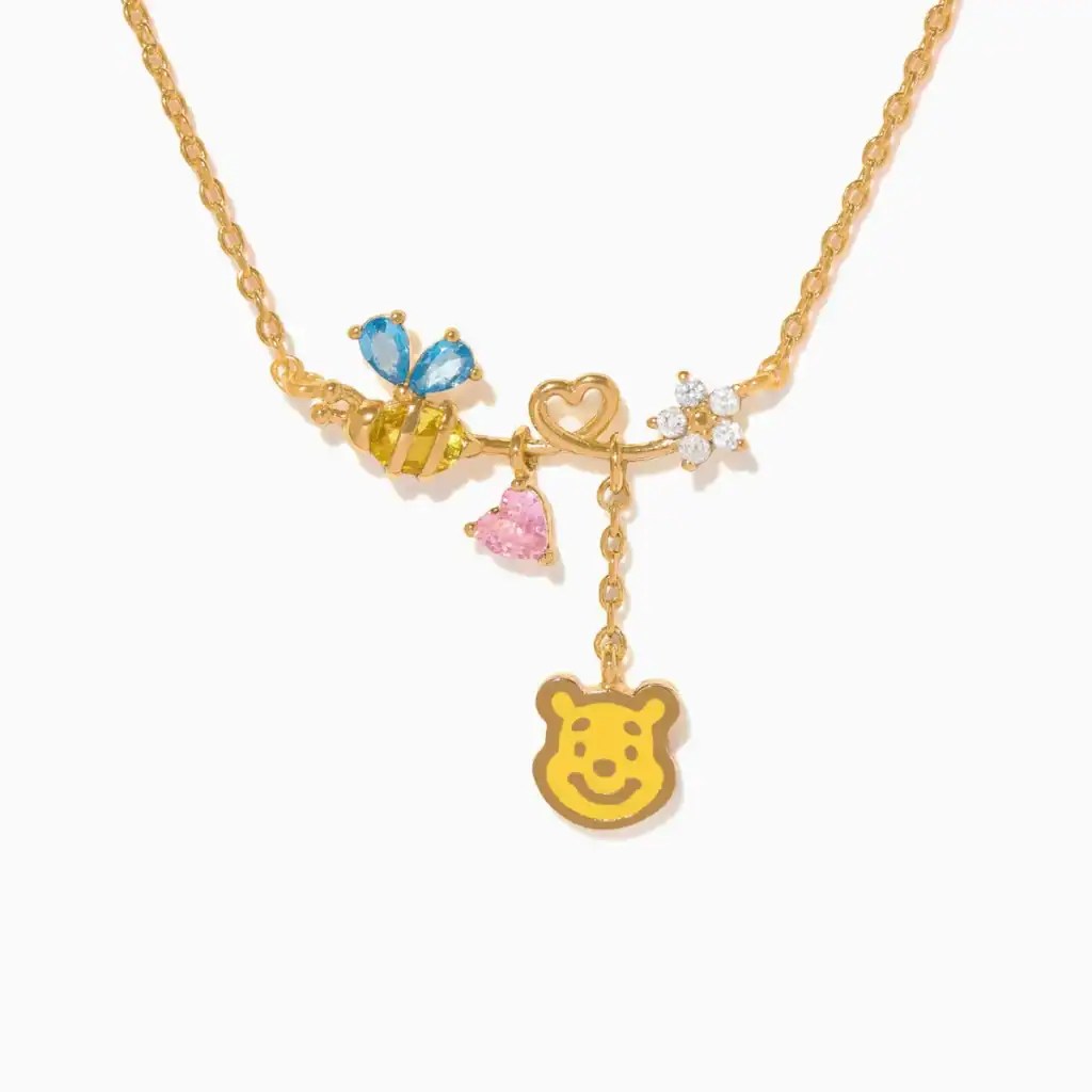 Cute Winnie the Pooh charm necklace with colorful charms and gold chain.
