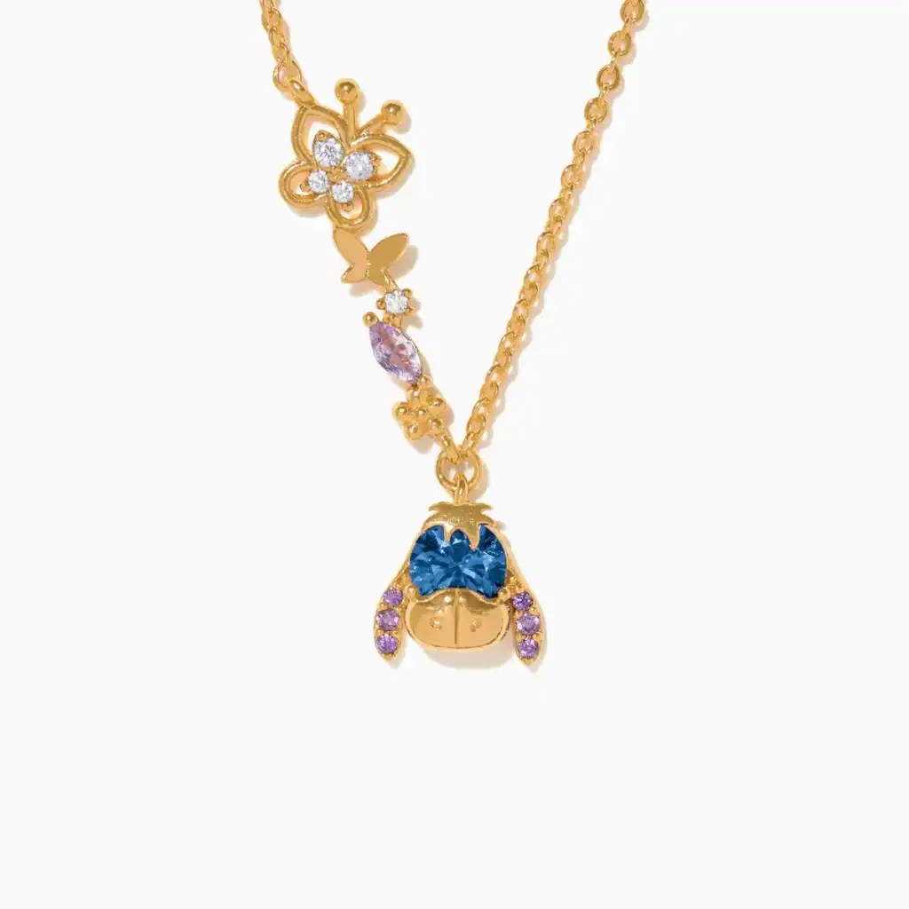 Elegant Disney-inspired necklace featuring a butterfly charm and a blue enamel princess pendant. Per.