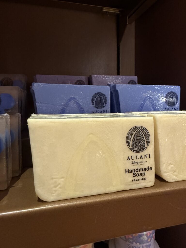 Colorful handmade soap bars displayed on store shelf at Disney Store.