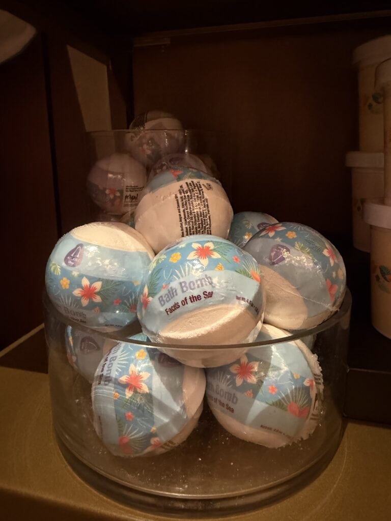 Brightly colored beach ball bath bombs with floral and ocean designs.