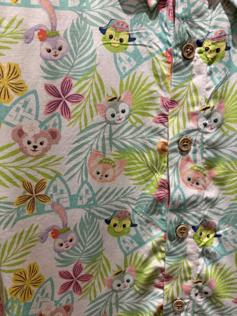 Colorful Disney-themed tropical shirt with cats, mice, and floral patterns.