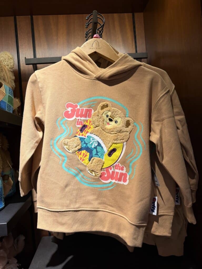 Cute Disney-themed bear hoodie for kids with colorful sun and surf design. Perfect for summer and ca.
