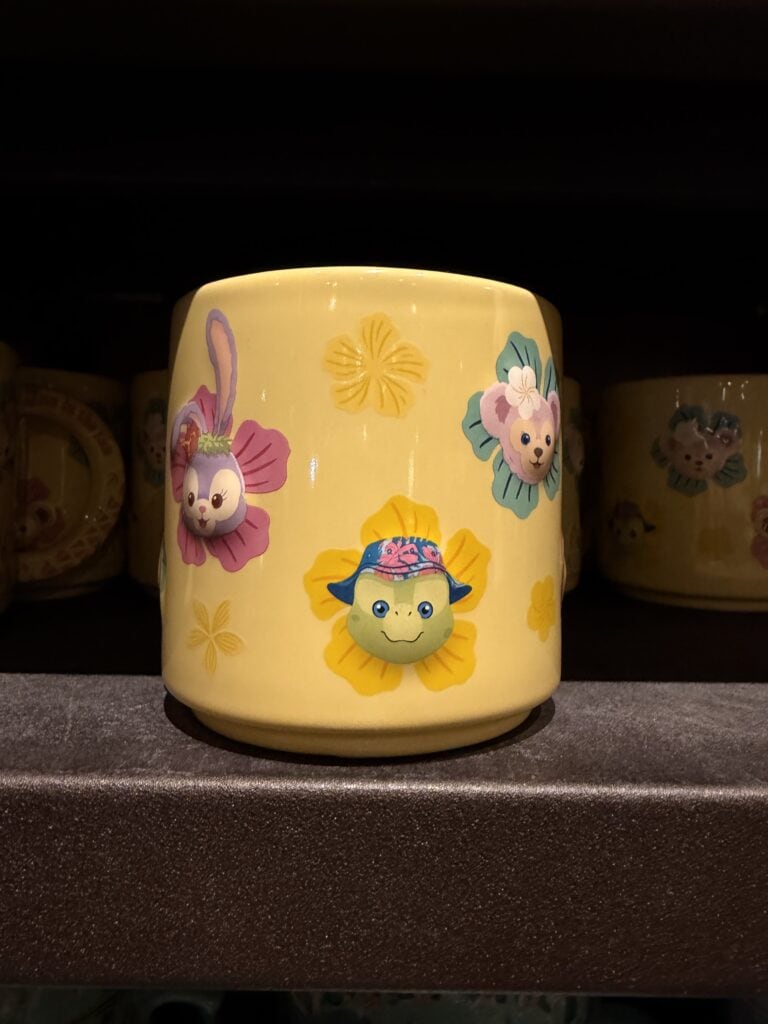 Cute Disney animal face mug with colorful floral accents, perfect for Disney fans and collectors.