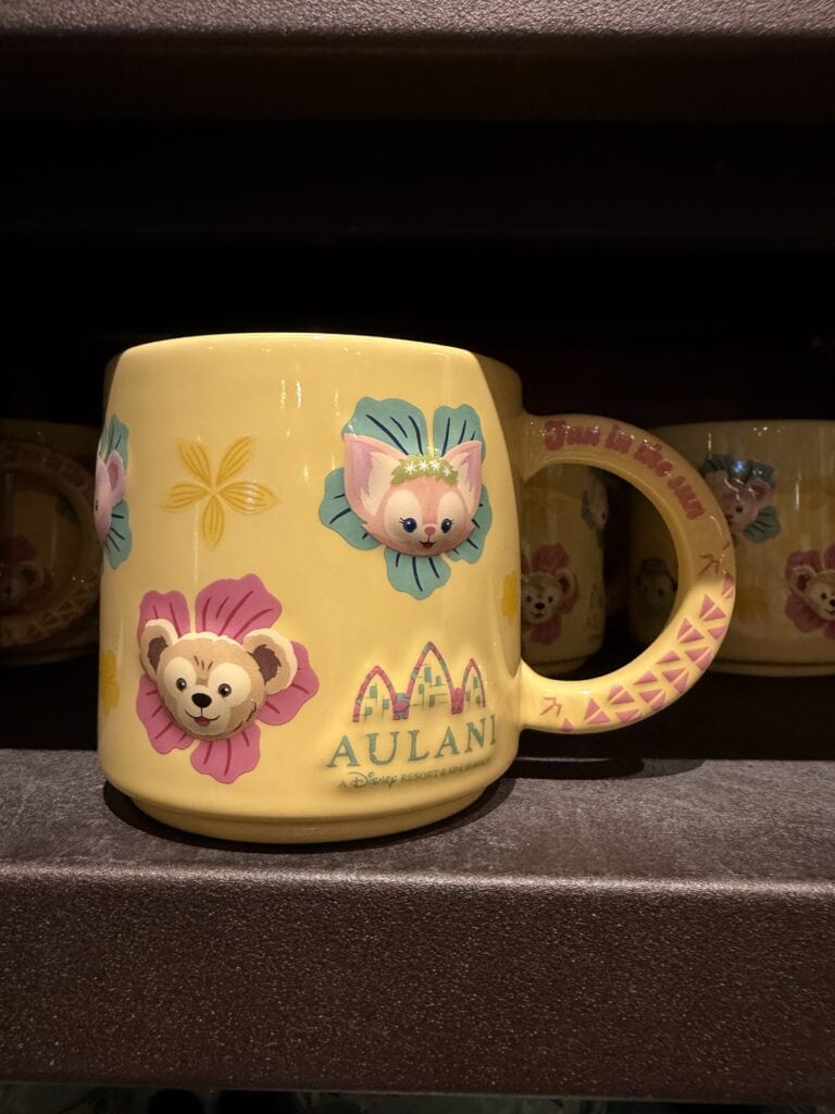 Colorful Disney mug featuring adorable animal faces and floral designs.