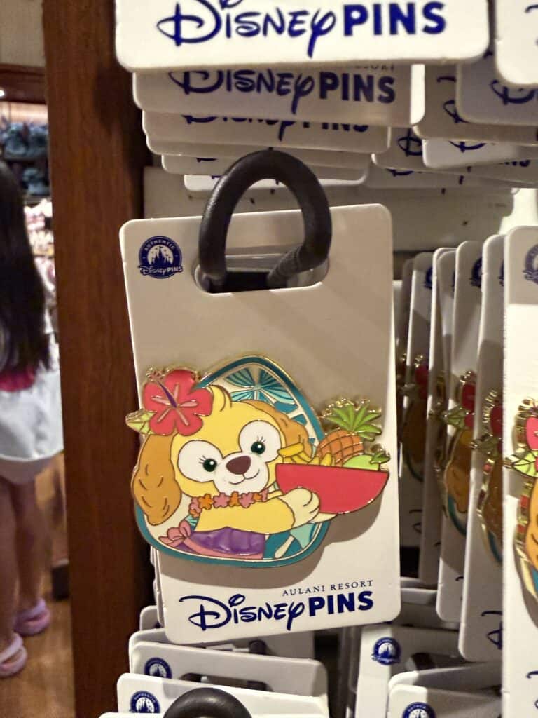 Disney Pins featuring Aulani Resort character with tropical design.