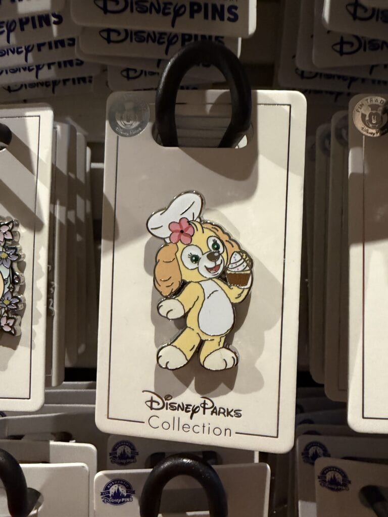 Daisy Duck Disney Parks pin featuring her with a pink bow and ice cream cone.