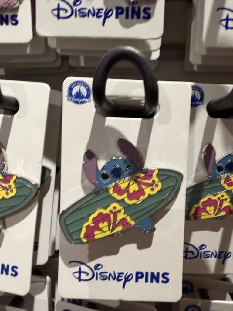 Disney Stitch surfboard pin on display at Disney store.