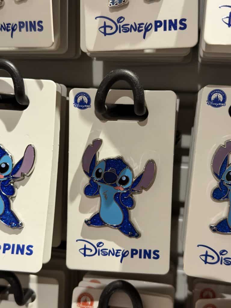 Disney Stitch enamel pin on display at Disney store.