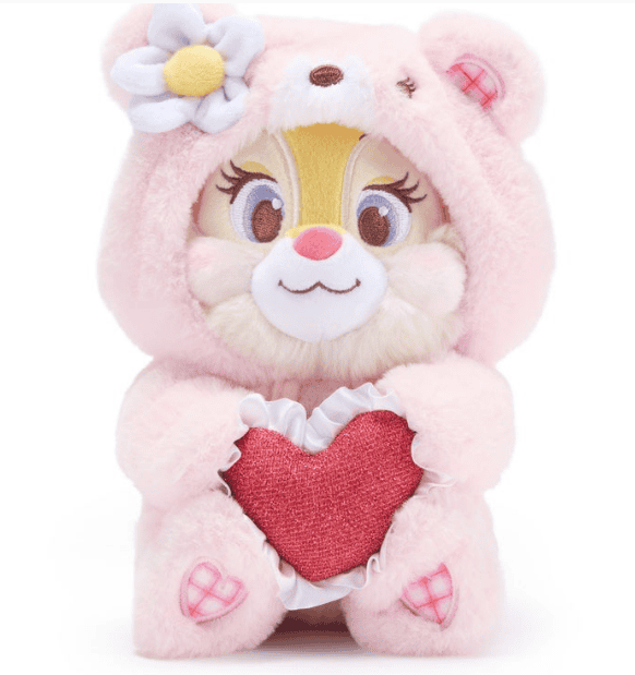 Adorable Disney plush toy wearing a pink bear costume holding a red heart.