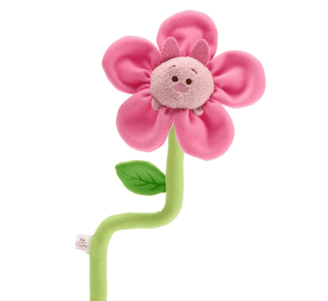 Adorable Disney plush flower toy with a smiling face, soft pink petals, and green stem.