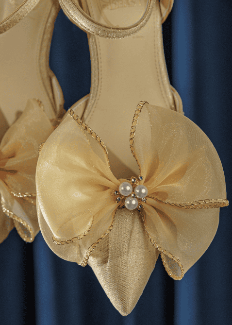 Elegant Disney-inspired ballet flats with pearl accents and gold trim.