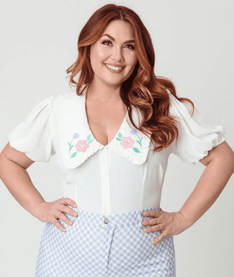 Woman wearing vintage-inspired Easter dress with floral collar and gingham skirt.